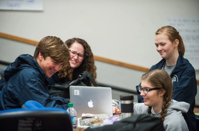 Emporia State students studying around laptop