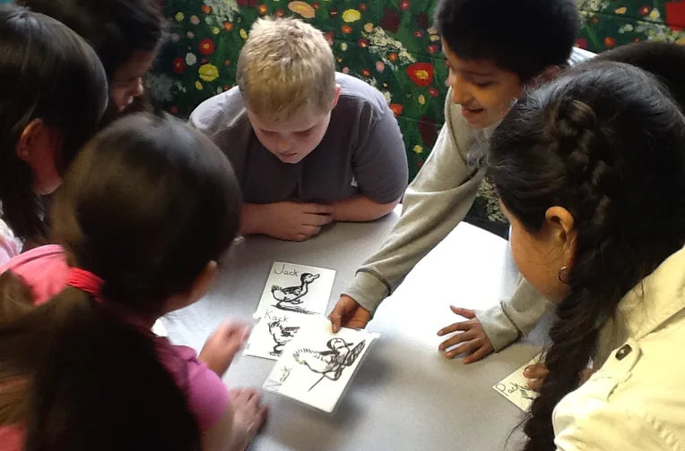 Group of children looking at flash cards