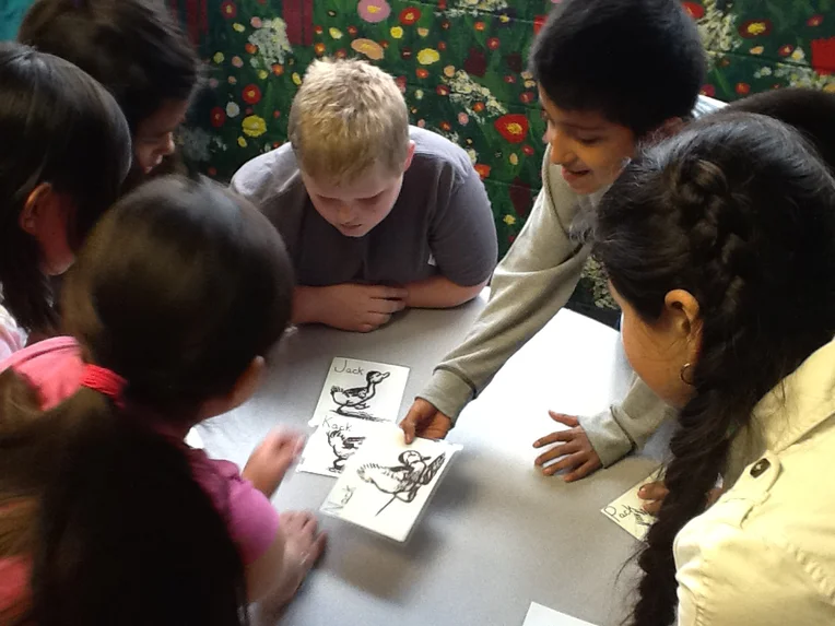 Group of children looking at flash cards