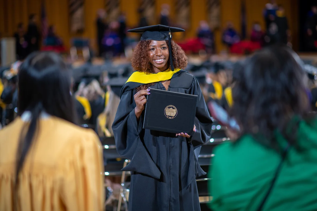 Student posing during commencement