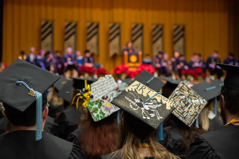 Close up of mortarboard decorated with image of Corky
