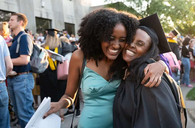 Hugging at graduation with Spanish and English students.