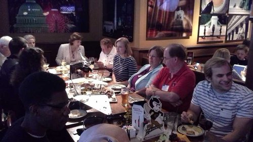 Group around a table eating dinner