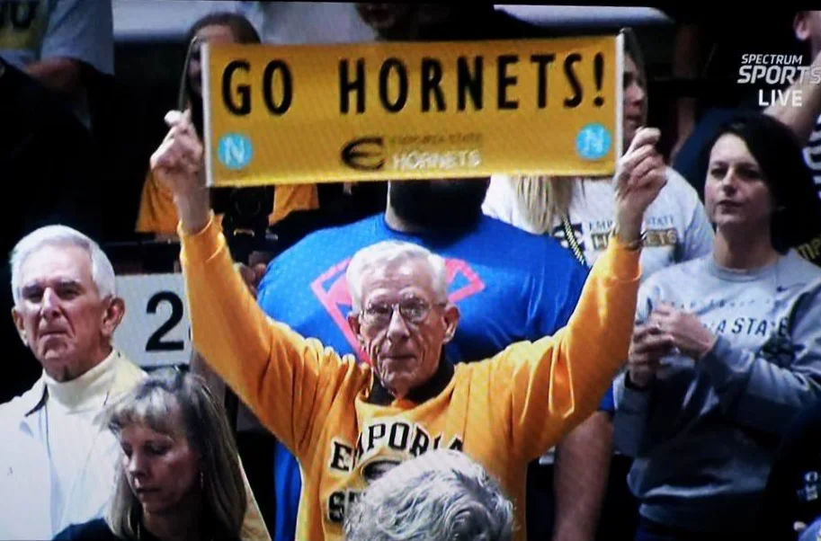 Robert Chatham holding a Go Hornets sign at an ESU game