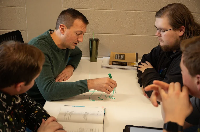 Mathematics professor and students solving a math problem