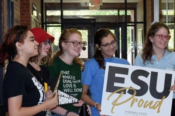 Emporia State students holding ESU proud sign