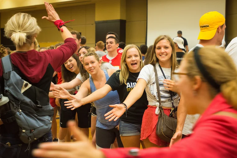 Emporia State students high-fiving each other