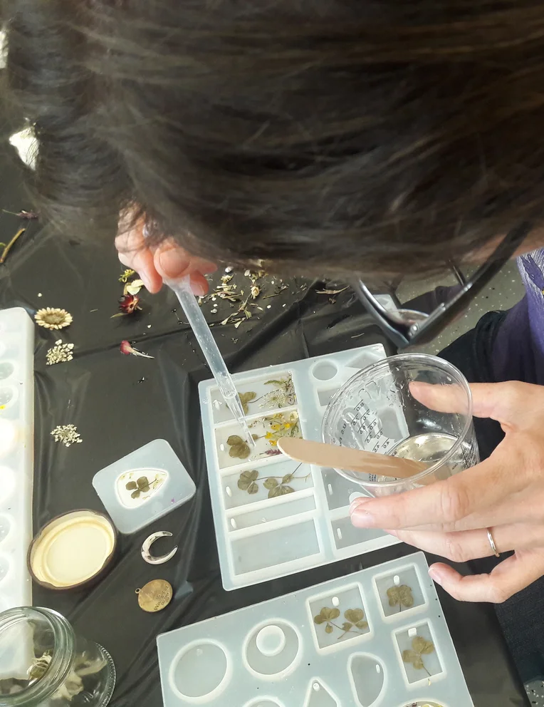 Student working with resin during Art Therapy program