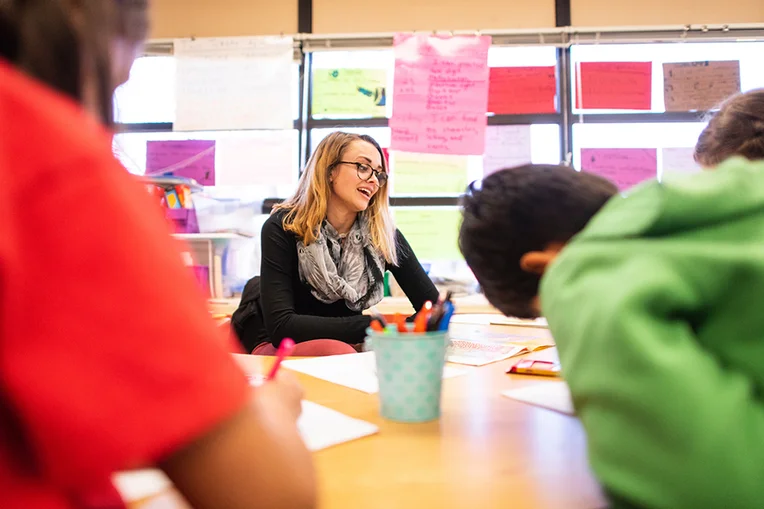 Student teacher working with children