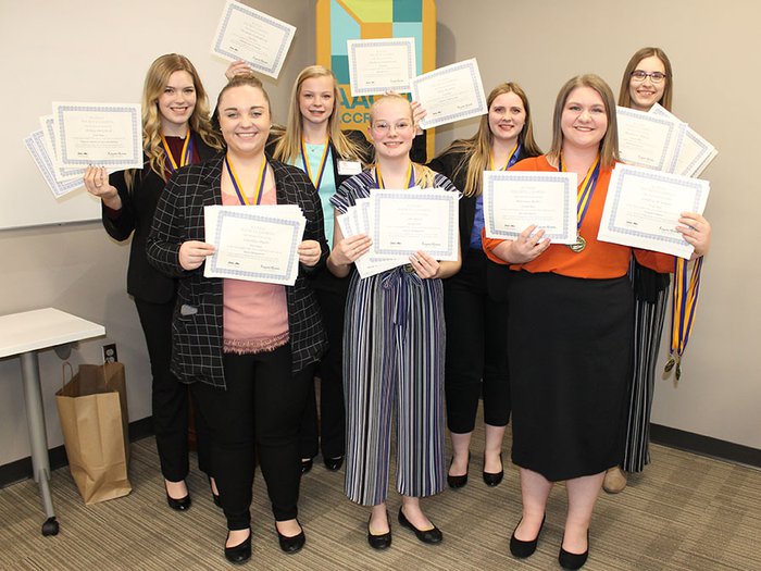 Students holding up certificates