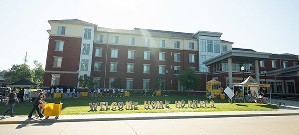 External view of residence hall with sign in front: Welcome Home, Hornets